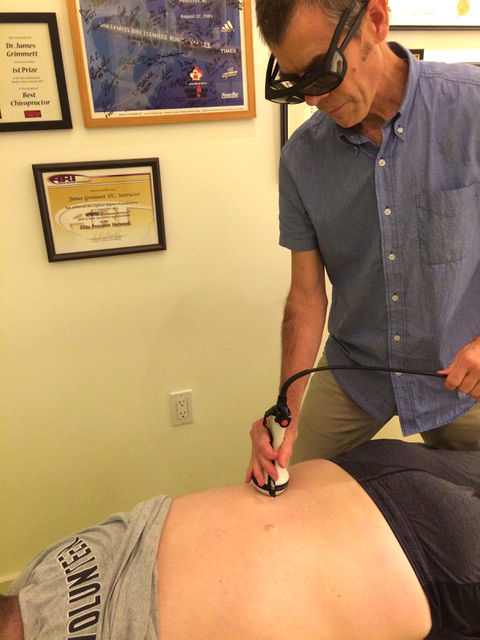 Dr Grimmett applying Laser Therapy 